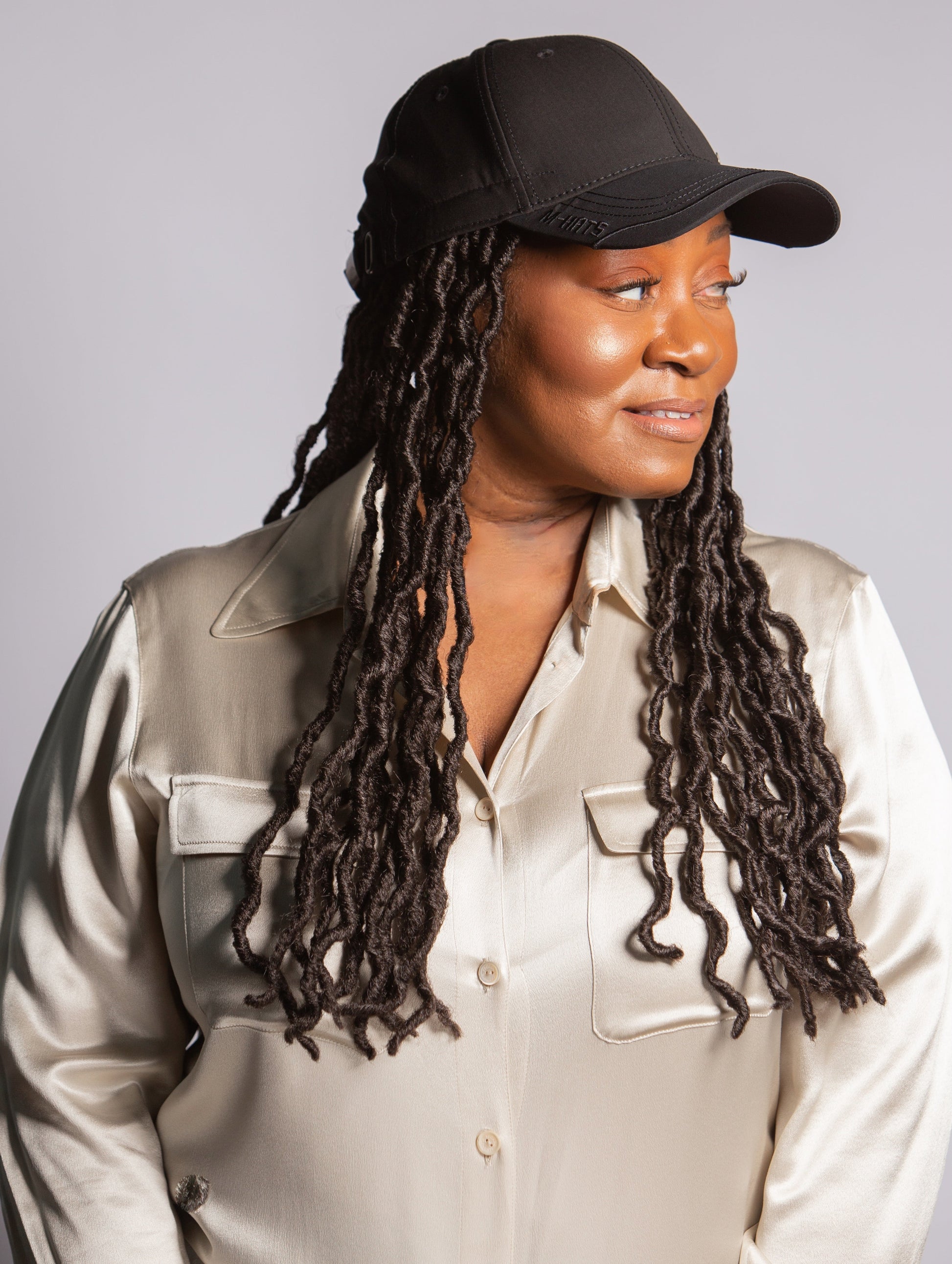 black woman wearing kimmie cap wig with cap